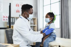 Pediatrician making Covid-19 vaccination for african girl