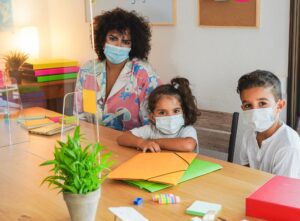 Teacher with children study with safety measures at school - Coronavirus lifestyle